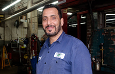 Smiling Saad-Albidhawi, a long time mechanic in his auto shop