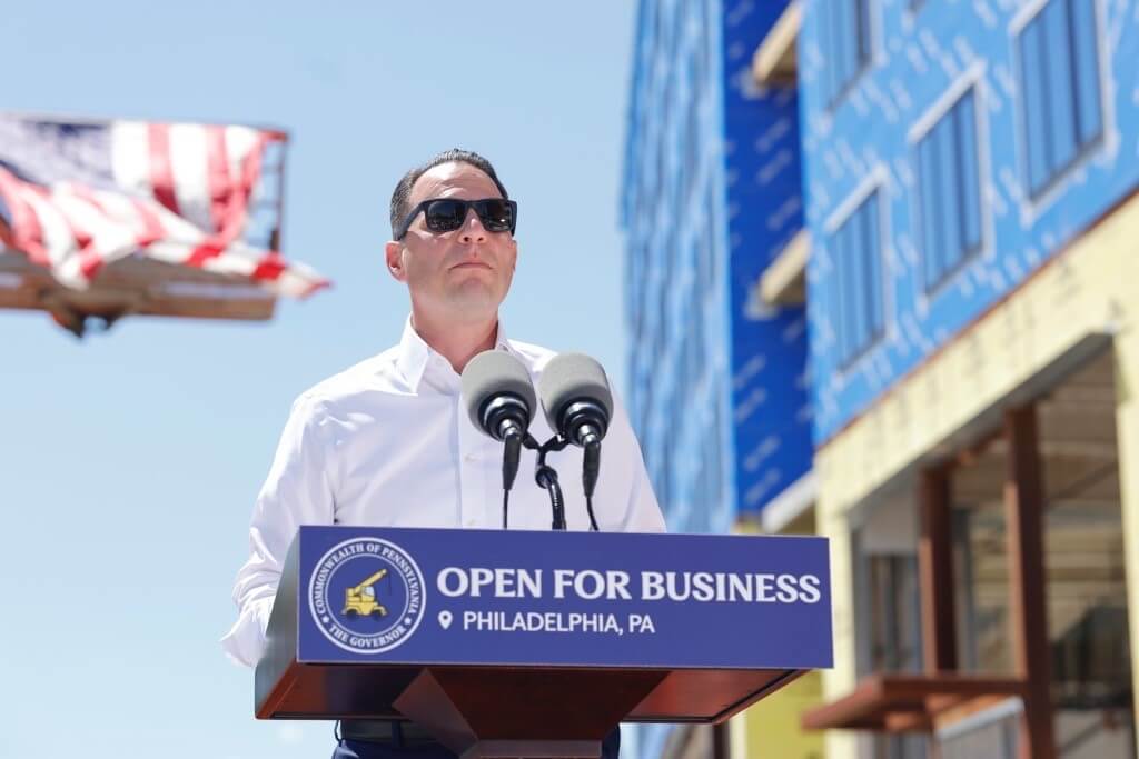 Pennsylvania Governor Josh Shapiro speaking from an outdoor podium during PA Sites Program Initiatives at Philadelphia