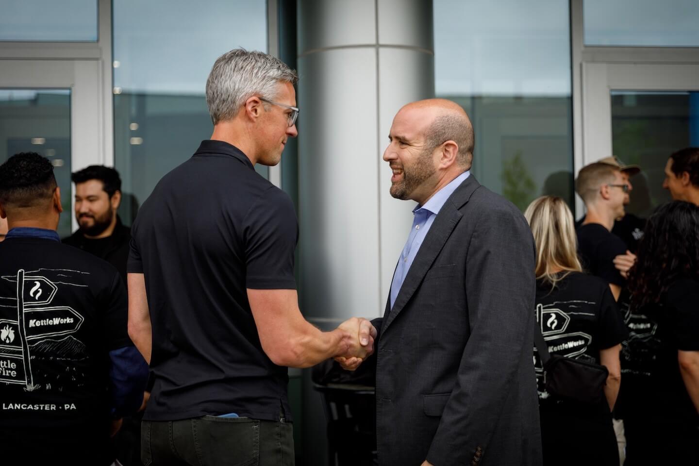 Secretary Rick Segar handshaking with Kettle & Fire official