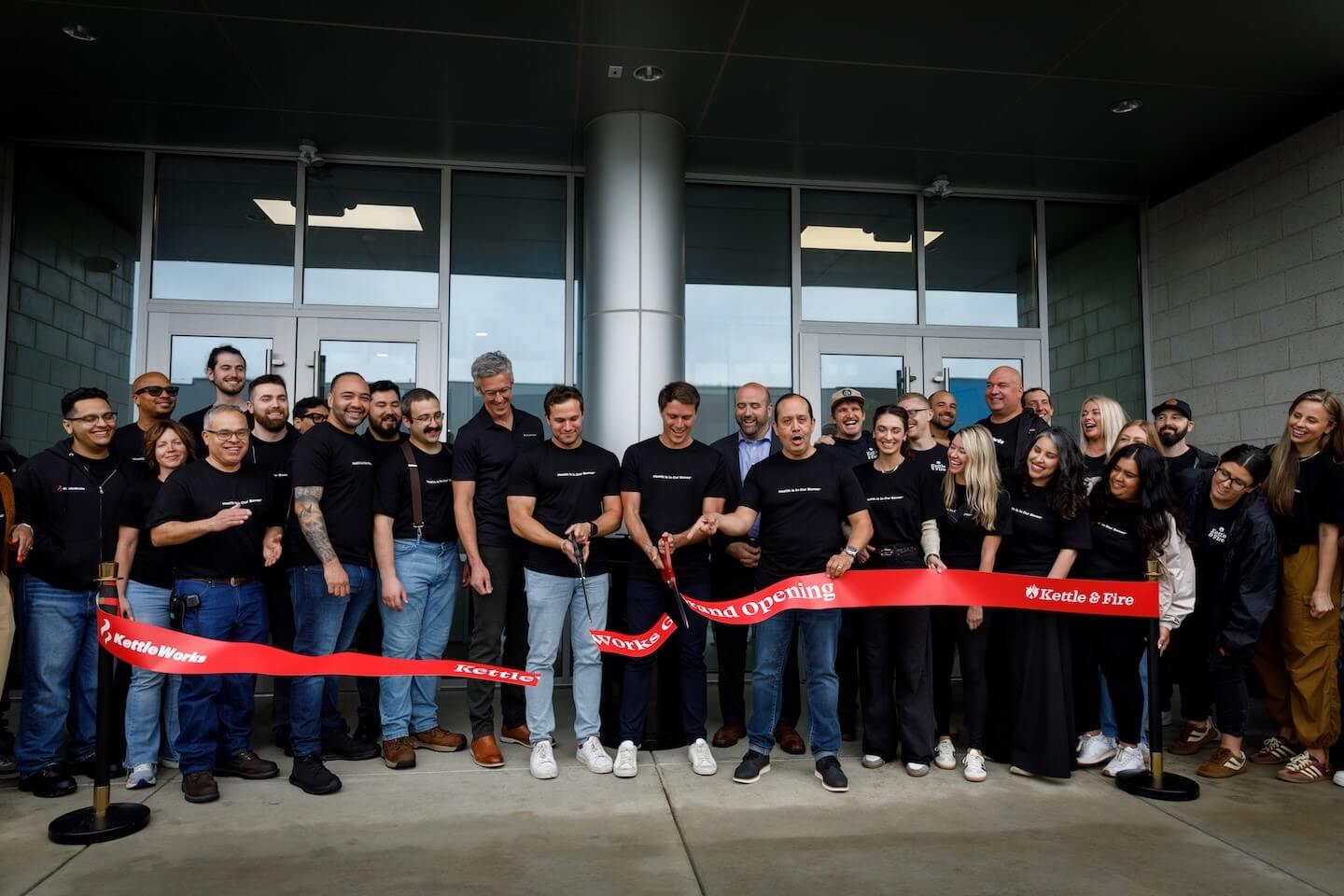 Ceremonial ribbon cutting with employees from Kettle & Fire to Build Food Manufacturing Facility