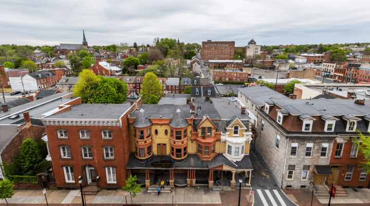An aerial view of downtown Lancaster with a row of red brick houses