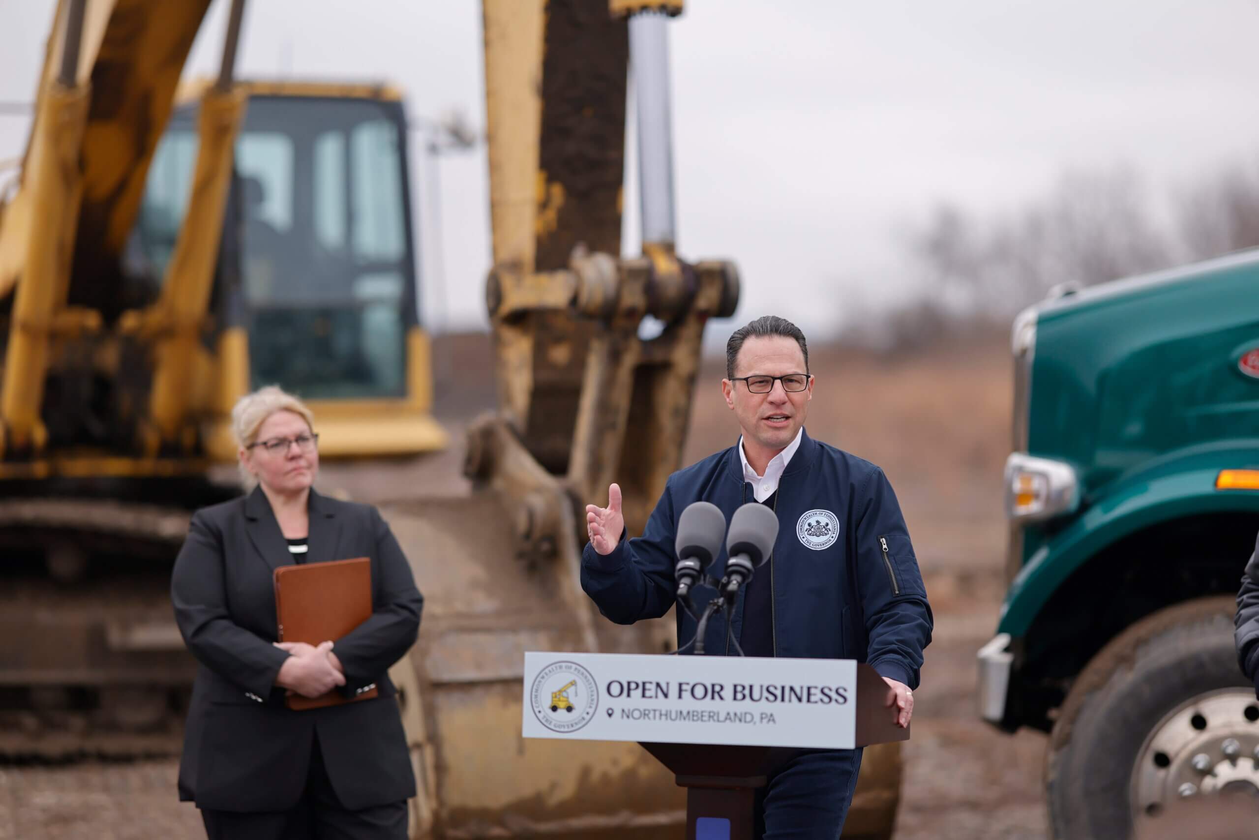 Pennsylvania Governor Josh Shapiro speaking from an outdoor podium in Northumberland County