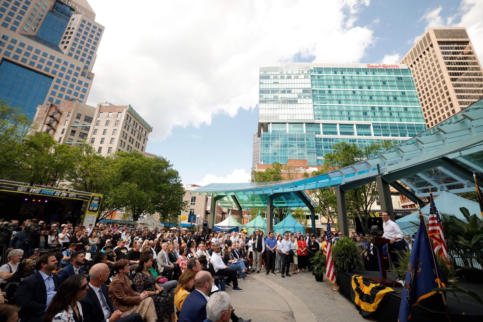 Pennsylvania Governor Josh Shapiro speaking from an outdoor podium in Downtown Pittsburgh