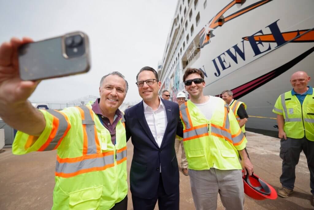 Governor Josh Shapiro posing with crew of Norwegian Cruise Line 