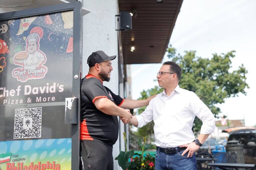 Governor Shapiro talking with shop owner