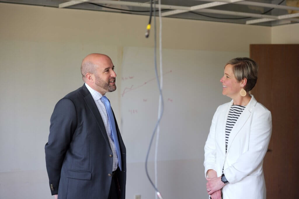 Secretary Rick Siger visiting a room under construction in the Washington Square Schoolhouse Apartments housing project in the City of Erie